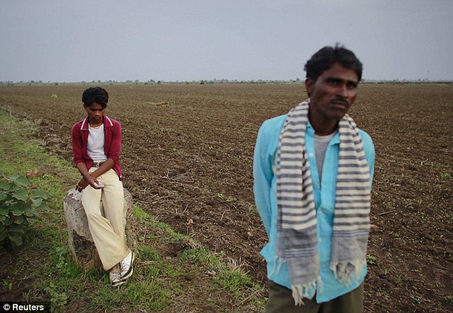 Reality: Gopal Kishan stands on the edge of the field that