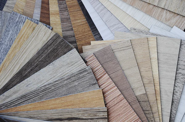 Laminate wood texture floor :oak tile, maple tile, chestnut tile, walnut tile, balsam tile,   Samples of laminate and vinyl floor tile on wooden Background. Laminate use in the house, Hospital, Townhouse, Condominium, Hotel, Apartment, Department Stock Photo